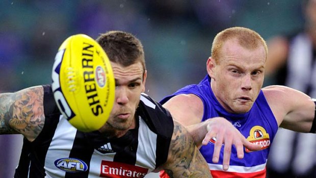 Race is on: Dane Swan and Adam Cooney battle it out at the MCG.