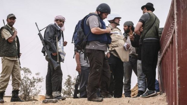 US reporter Steven Sotloff (centre) at work in Libya in 2011. The reporter was executed by Islamic State this week.