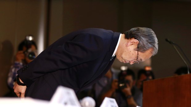 Toshiba President Satoshi Tsunakawa bows after announcing its US nuclear unit Westinghouse had filed for bankruptcy protection. 