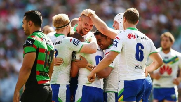 Try time: Raiders players congratulate Dane Tilse after he scored one of the team's five tries against South Sydney on Sunday.