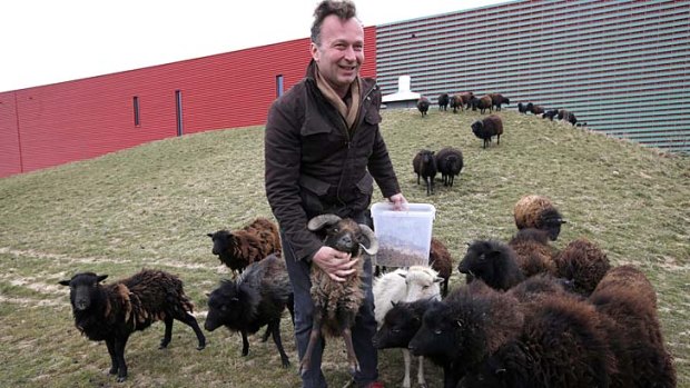 Natural lawnmovers: Sylvain Girard, owner of "Ecomouton" shows his flock used to graze the lawns in replacement of lawn mowers around a truck warehouse at Evry, south of Paris.