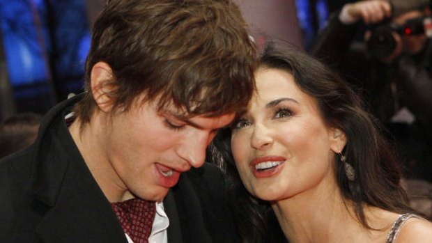 Just lean over and tell her! ... Ashton Kutcher is keeping his engagment news from ex Demi Moore.