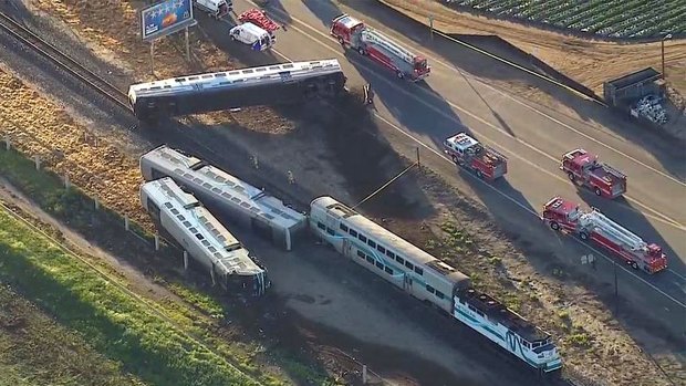 Three cars of the Southern California Metrolink commuter train derailed and tumbled onto their sides after the collision on tracks northwest of Los Angeles. 