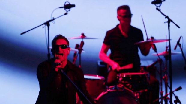 U2 members Bono, left, and Larry Mullen Jr perform during an announcement of new products by Apple on Tuesday in Cupertino, California.