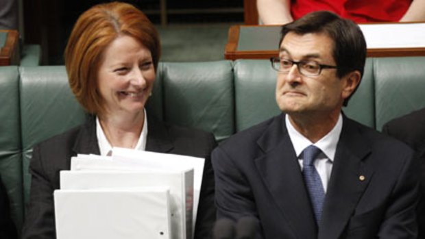 All the work of others ... Julia Gillard and right, Greg Combet discovers a warm sense of satisfaction.
