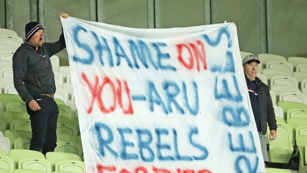 Rebels supporters in the crowd hold a sign aloft during the match between the Rebels and the Brumbies.