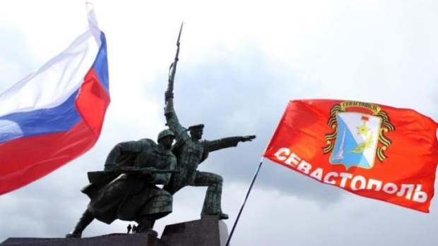 Flags flutter during celebrations in Sevastopol on March 18, 2015, to mark one year since Russian President Vladimir Putin signed off on the annexation of Crimea.