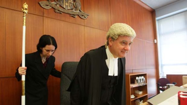 Change from the daily grind...Justice Michael Slattery prepares to deliver a judgment.