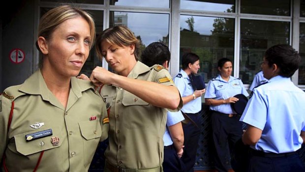 ''We wear it with pride'' &#8230; Corporal Renae Fritzell-Flint adjusts the uniform of her partner, Corporal Danielle Gurkin.