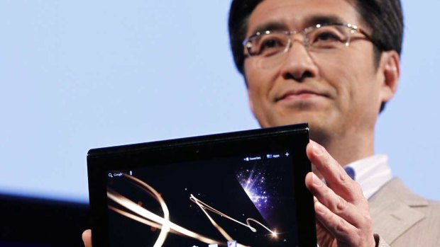 Kunimasa Suzuki, Deputy President of Sony's consumer products and services group, holds Sony's first tablet PC S1 at its unveiling ceremony in Tokyo.