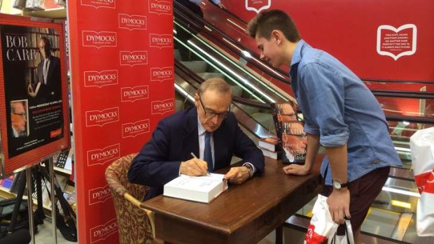 Bob Carr signs copies of his new book, Diary of a Foreign Minister, at Dymocks in Brisbane City on Wednesday.