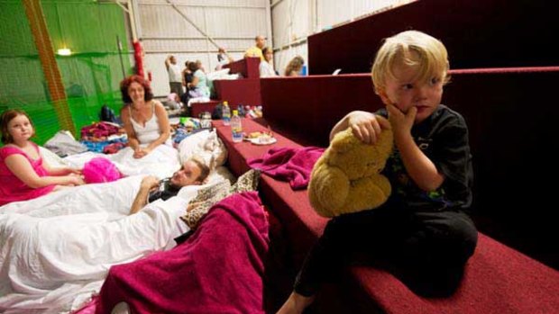Damien Vieritz, 2, gets ready for bed at the evacuation centre at the Ipswich Showgrounds.