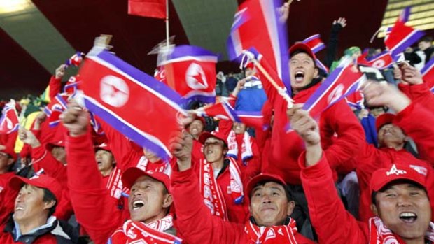 Supporting their team ... the North Korea fans picked to travel to South Africa cheer on their side.