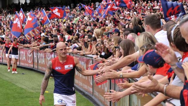 Nathan Jones and his teammates celebrate with Melbourne fans after their win over Richmond at the MCG yesterday.