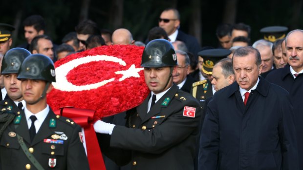 Turkish President Recep Tayyip Erdogan, right, follows a military honour guard to the mausoleum of the republic's founder Mustafa Kemal on October 29,  Republic Day.
