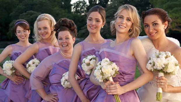 Vow row ... (from left) Ellie Kemper, Wendi McLendon-Covey, Melissa McCarthy, Rose Byrne, Kristen Wiig and Maya Rudolph join the wedding party.