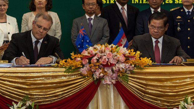 Australia's then immigration minister Scott Morrison and Cambodian Interior Minister Sar Kheng sign an agreement to resettle refugees in Cambodia.