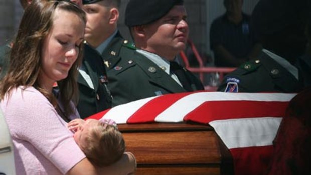 Homecoming ... Brooke Jenkins holds her daughter, Reagan, as the body of her husband, Captain Cory Jenkins, is returned from Afghanistan. Captain Cory Jenkins died when a bomb blew up his Stryker armoured vehicle in southern Afghanistan last week.