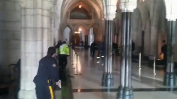 Police officers respond to shooting attacks inside the Centre Block of the Parliament buildings in Ottawa.