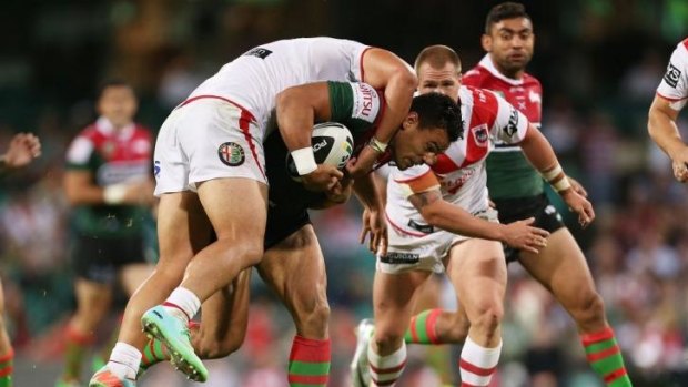 Souths forward Ben Te'o carries a Dragons defender at the SCG.