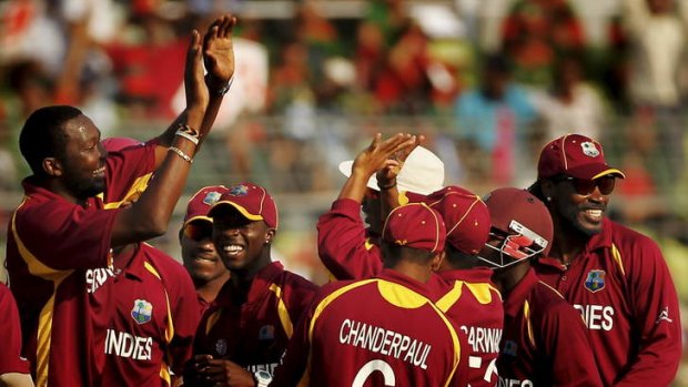 At risk: West Indies players celebrate taking a wicket during the 2011 ICC World Cup against Bangladesh in Dhaka. The West Indies team bus was stoned as they returned to their hotel.