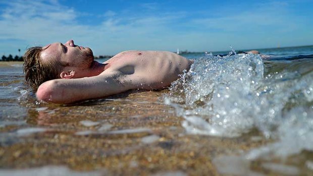 Elwood Knowles seeks respite in the shallows at St Kilda beach.