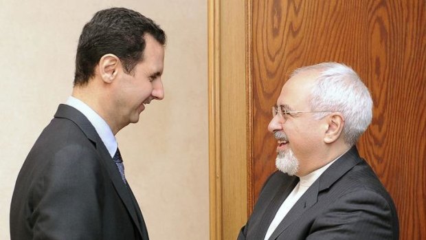Syria's President Bashar al-Assad (L) welcomes Iran's Foreign Minister Mohammad Javad Zarif before a meeting in Damascus.