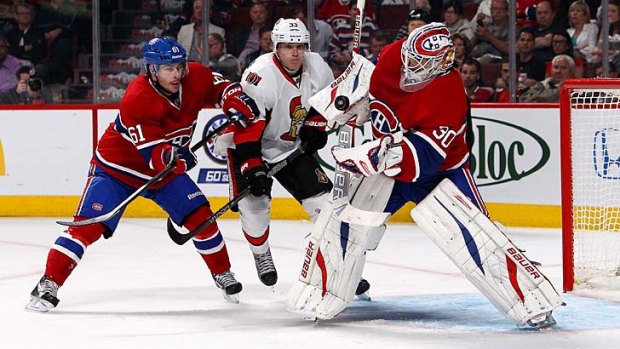 Jakob Silfverberg (33) of the Ottawa Senators looks for a rebound as Peter Budaj (30) of the Montreal Canadiens makes the save and Raphael Diaz (61) of the Canadiens defends.