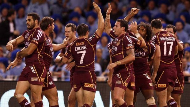 Queenslander ... the Maroons celebrate a try during last night's Origin match.