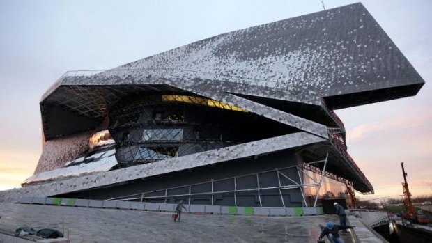 Labourers work at the new Philharmonie de Paris ahead of its opening on Wednesday. The concert hall is located in the north-east of the capital and has generated a lot of enthusiasm but also controversy for its budget blowout.