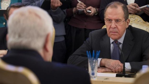 Russian Foreign Minister Sergey Lavrov, right, listens to his Syrian counterpart Walid al-Moallem, left, during a meeting in Moscow