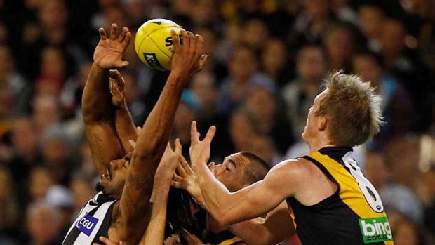 Magpies defender Harry O'Brien spoils Jack Riewoldt's attempt to mark.