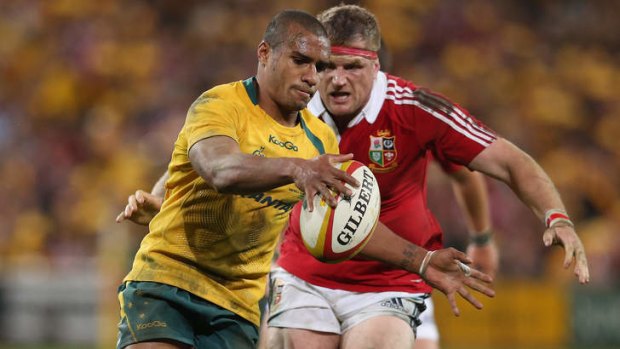 Will Genia of the Wallabies gets tackled by Jamie Heaslip of the Lions during the first Test match in Brisbane.