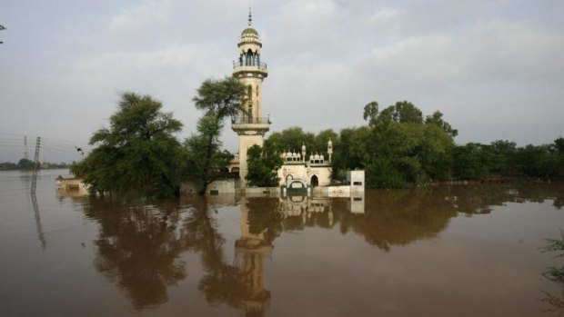 A mosque is seen partially submerged by floodwaters after heavy rain in Wazirabad, Pakistan. At least 73 people have been killed in the country due to flooding.