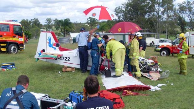 Emergency workers try to free the injured female pilot of a light plane that crashed near Gatton.