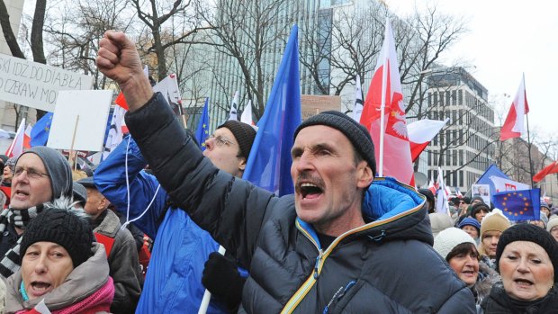 People shout slogans as anti-government protesters gather in front of the Constitutional Court in Warsaw, Poland.