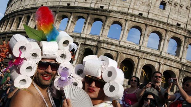 EuroPride participants strut their stuff in front of Rome's Colosseum.