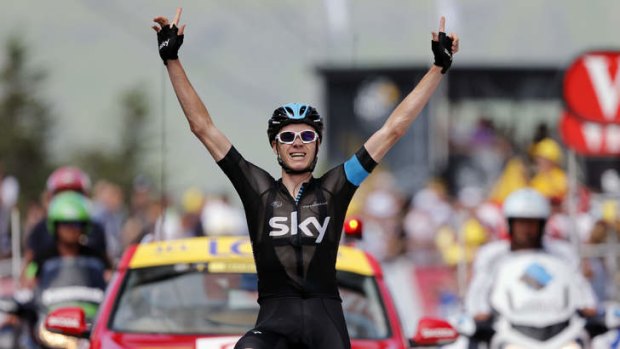 Britain's Christopher Froome celebrates as he crosses the finish line at the end of the 195 km eighth stage of the 100th edition of the Tour de France .