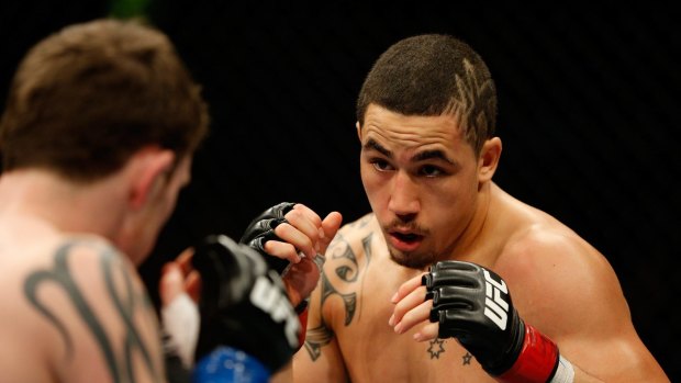 Fired up: Robert Whittaker takes on Brad Tavares  in Adelaide on Sunday.