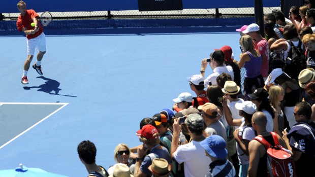 A supportive crowd gathers on court 16 yesterday to watch Lleyton Hewitt practise for tonight's crunch match with world No. 1, Roger Federer.