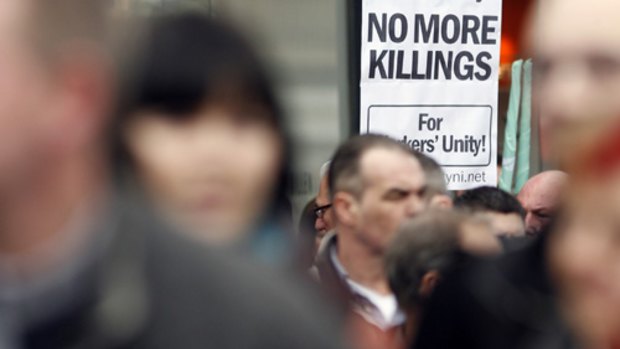 A poster calling for a end to the killings in Northern Ireland, seen outside Belfast City Hall, Northern Ireland.