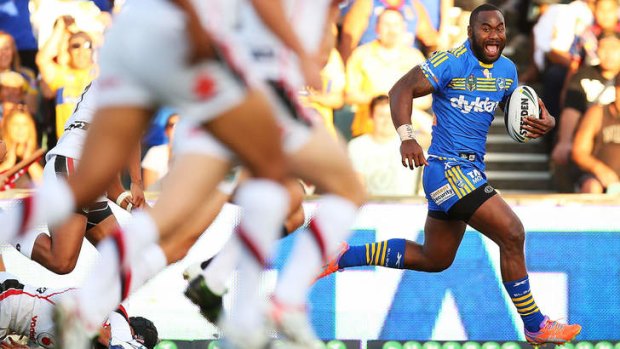 Hat-trick: Semi Radradra of the Eels on the way to one of his three tries against the Warriors.