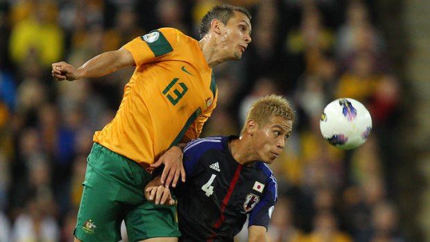 Jade North and Keisuke Honda compete for the ball.