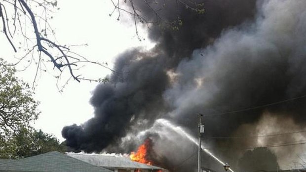 Smoke billows near an apartment complex where a Navy jet crashed.