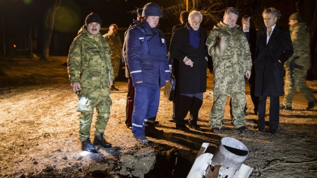 Ukrainian President Petro Poroshenko looks at an unexploded rocket in the eastern Ukrainian city of  Kramatorsk during a visit on Tuesday.