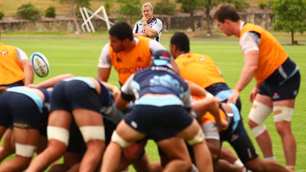 Push comes to shove ... coach Chris Hickey looks on as the Waratahs forwards pack down yesterday.
