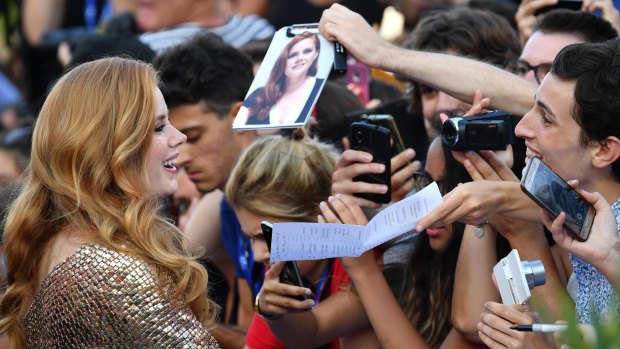 US actress Amy Adams meets fans as she arrives on the red carpet for the movie Nocturnal Animals at the Venice Film Festival.