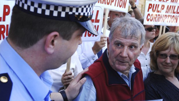 Peter Cundall is arrested outside Tasmania's Parliament House in Hobart.