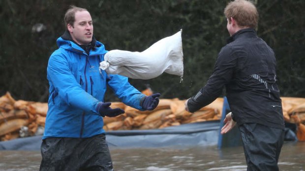 Royal aid: The Duke of Cambridge and Prince Harry help build flood barriers in Datchet.