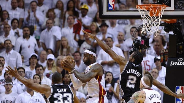 LeBron James catches the ball under the basket during the third quarter of Game 7.